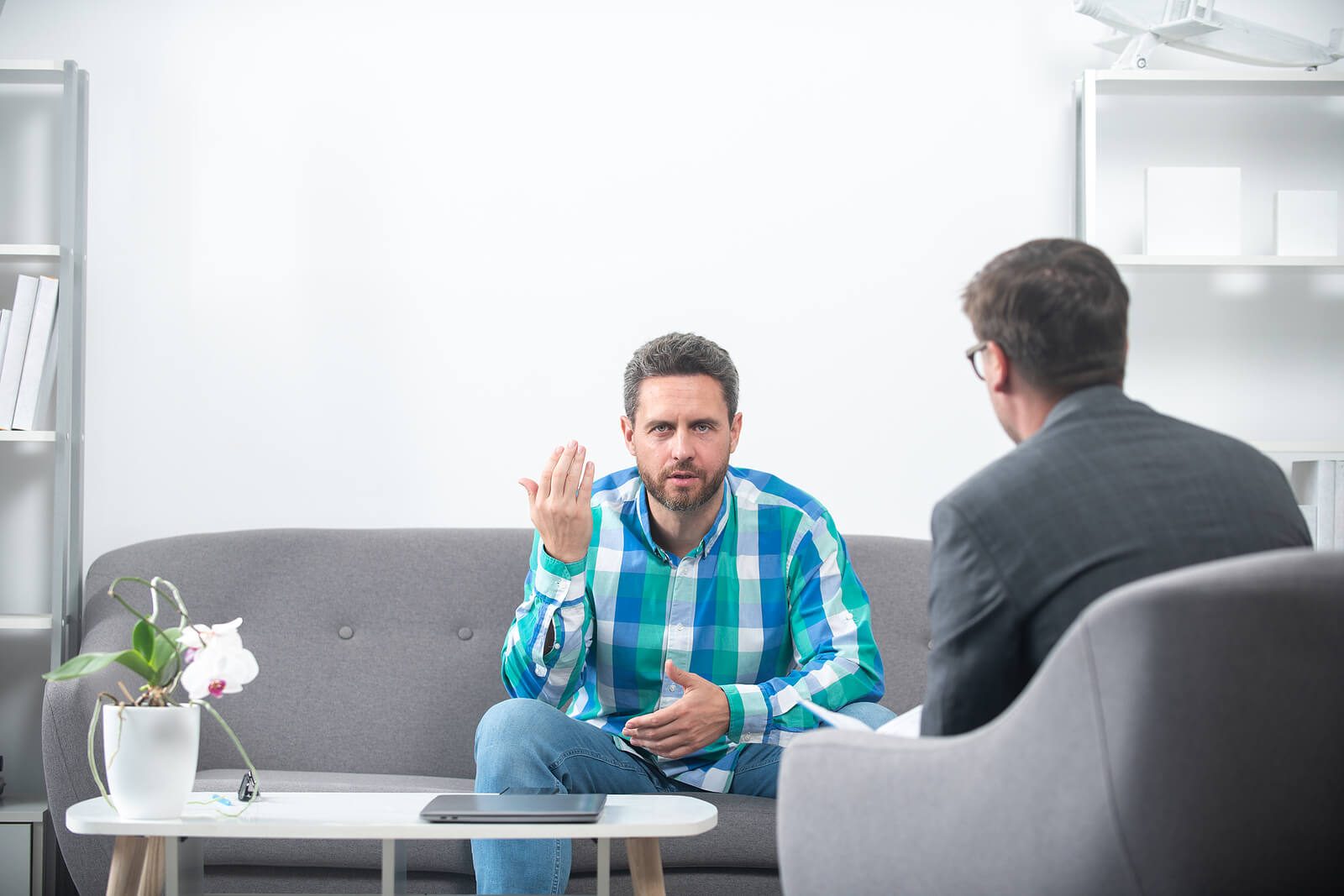 emotional strength in mount pleasant, wi | mens therapy | mens therapist | Racine | Milwaukee | Madison A man talking with a therapist during a counseling session, gesturing with his hand while the therapist takes notes. Find emotional strength and balance with the support of men's therapy in Mount Pleasant, WI.