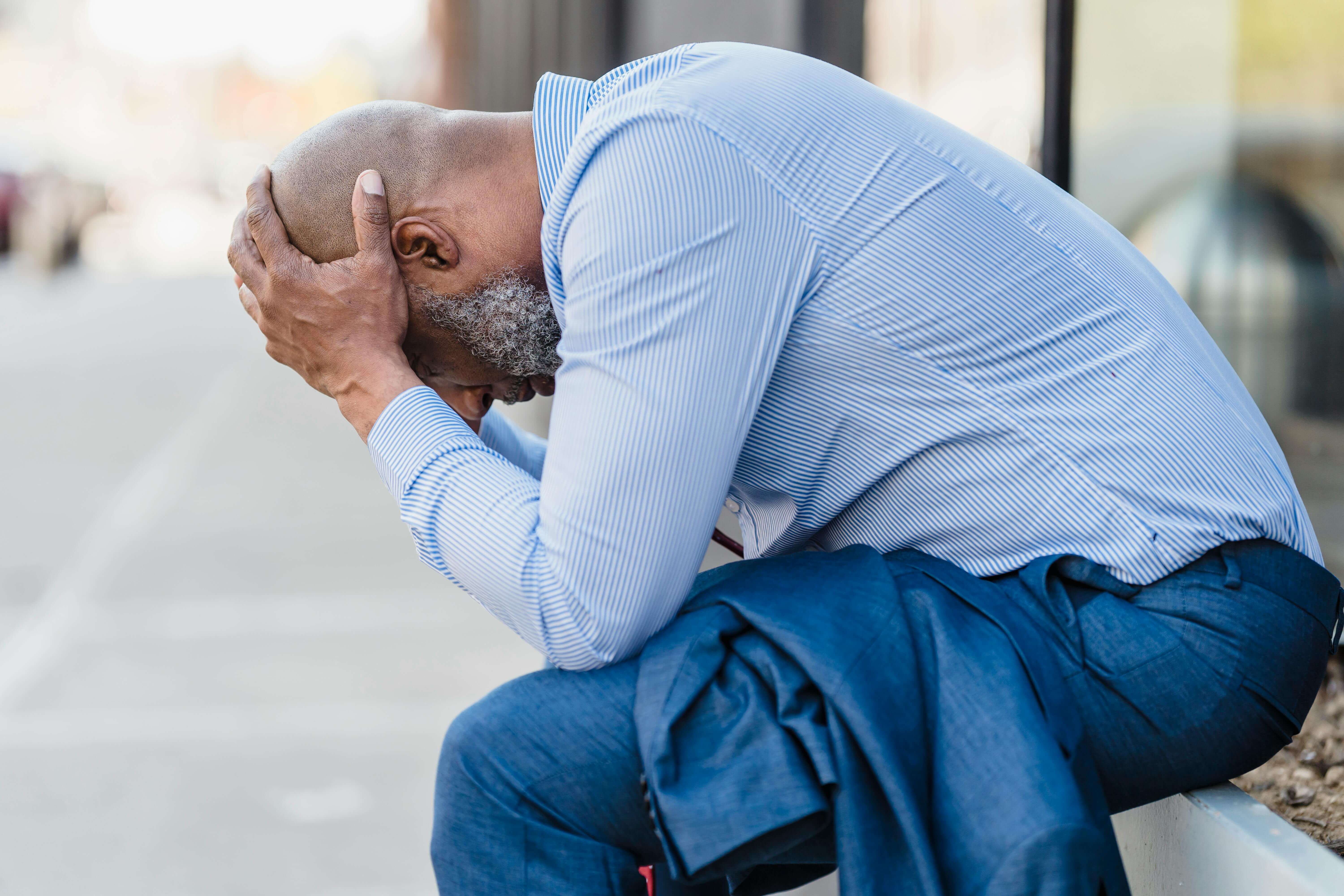 upset man | mens therapy in racine, wi | mens therapist | mens anxiety | Mount Pleasant | Burlington | Lake Geneva Upset man sitting outside with his head in his hands. With the support of a compassionate men's therapist in Racine, WI you can begin to cope with your anxiety symptoms in healthy ways.